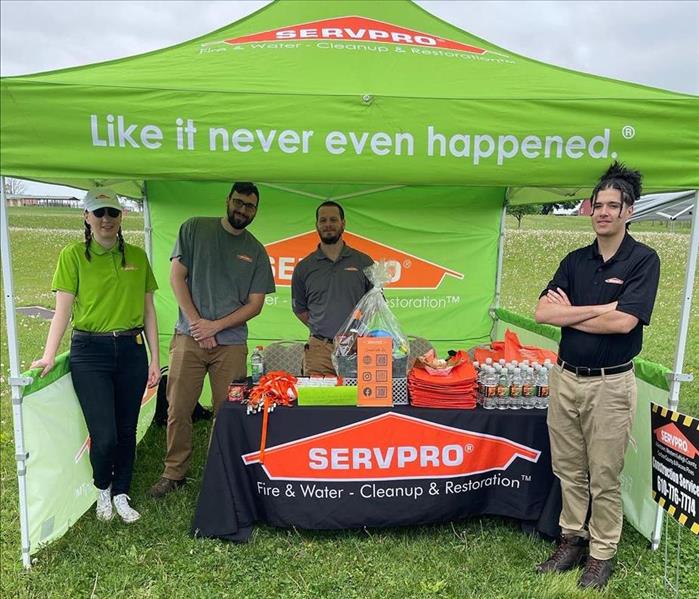 A SERVPRO tent with staff